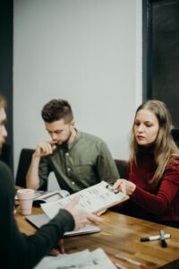 a group of three people working on a brand project approval of a brand discussion