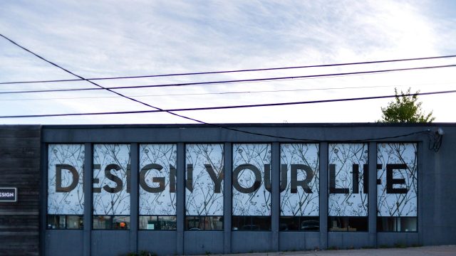 design your life banner on a wall of street side walk