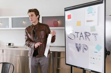 a man explaining a startup business idea with a vision board